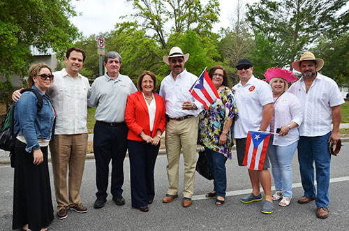 Mayor Teresa Jacobs is joined by Mercedes Fonseca, Orange County Clerk of Courts Eddie Fernández, Orange County Commissioner Pete Clarke, City of Orlando Commissioner Tony Ortiz, Ana Cruz, Luis Urra, Carmen Acevedo and Eduardo Rivera at the Puerto Rican Parade and Festival on Sunday.