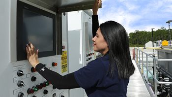Image of a utility personel viewing a monitor